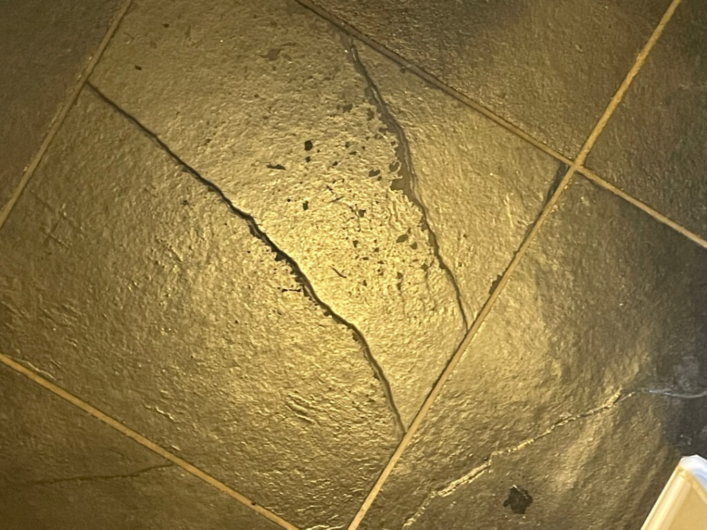 cracked tile floor from crawl space settlement