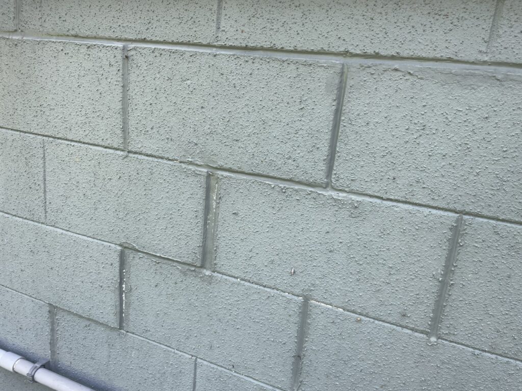 The homeowners tried to fill in the structural cracks in block gaps with mortar; this cosmetic fix did not address the foundation issues.