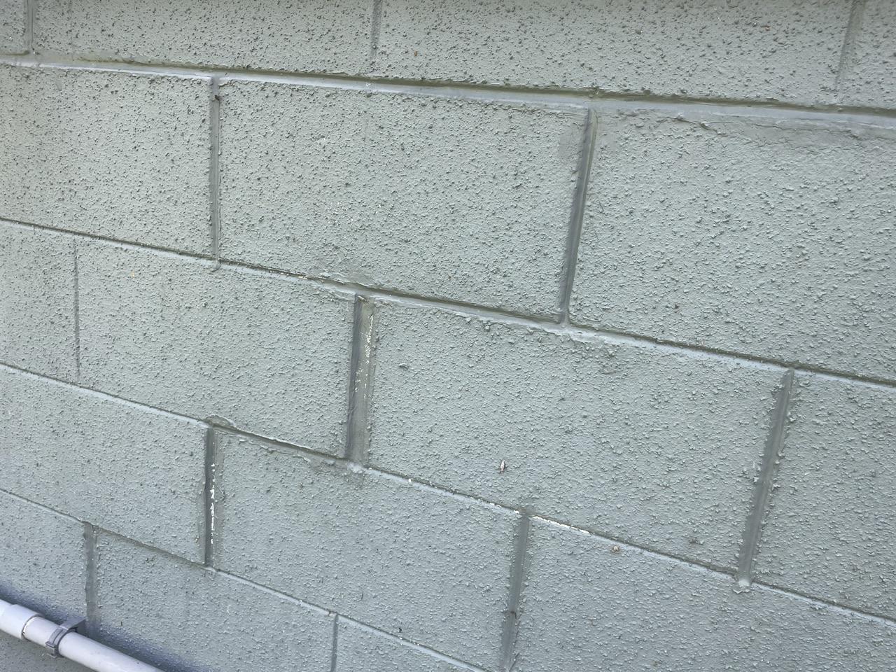 tried to fill in the block gaps with mortar; this cosmetic fix did not address the foundation issues.