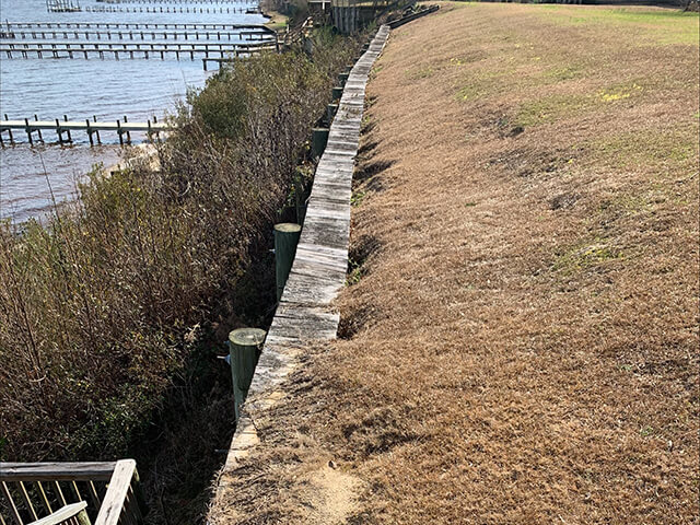 seawall with erosion and voids opening up behind the seawall
