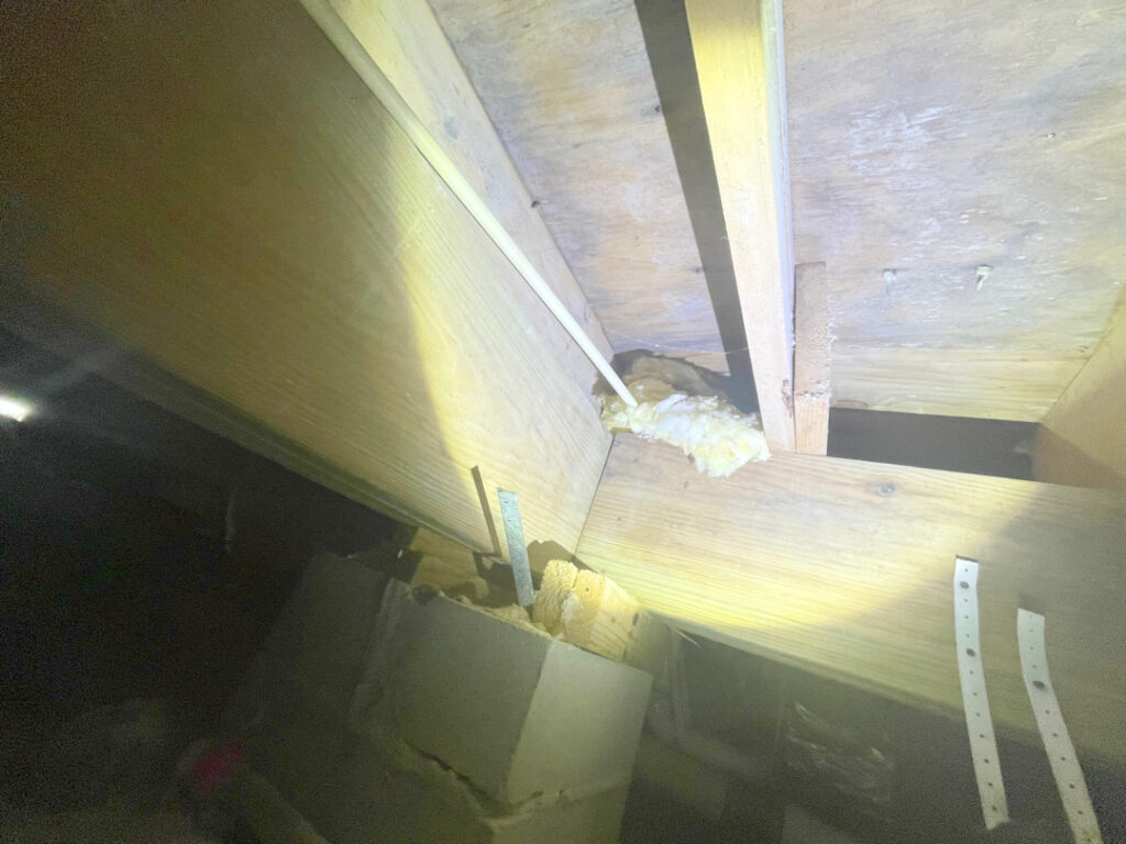 previous wooden shims were unsuccessful at reinforcing the crawl space foundation